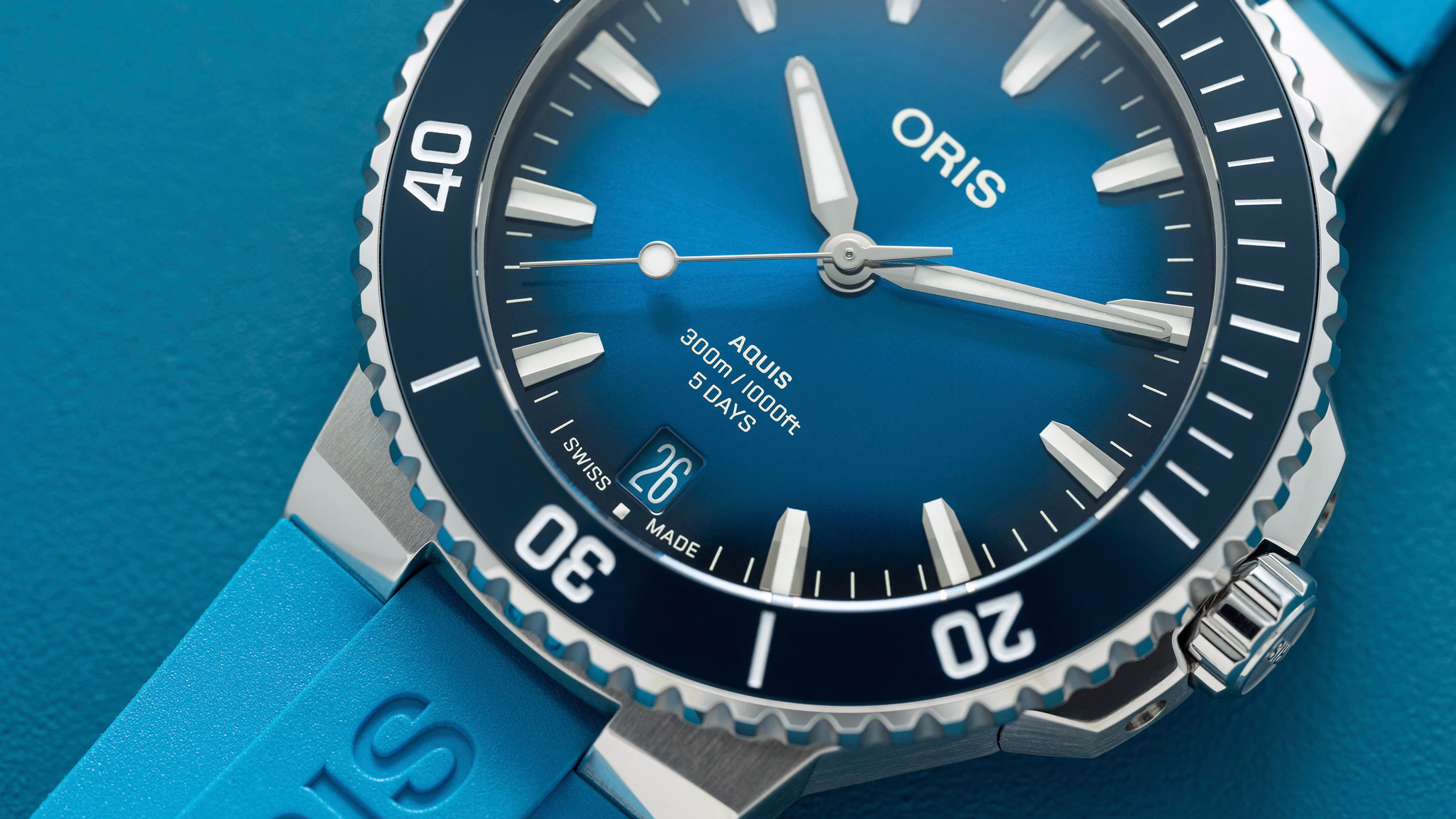 Oris Aquis diver watch with blue rubber strap demonstrating reliable water resistance for monsoon season and rainy weather protection