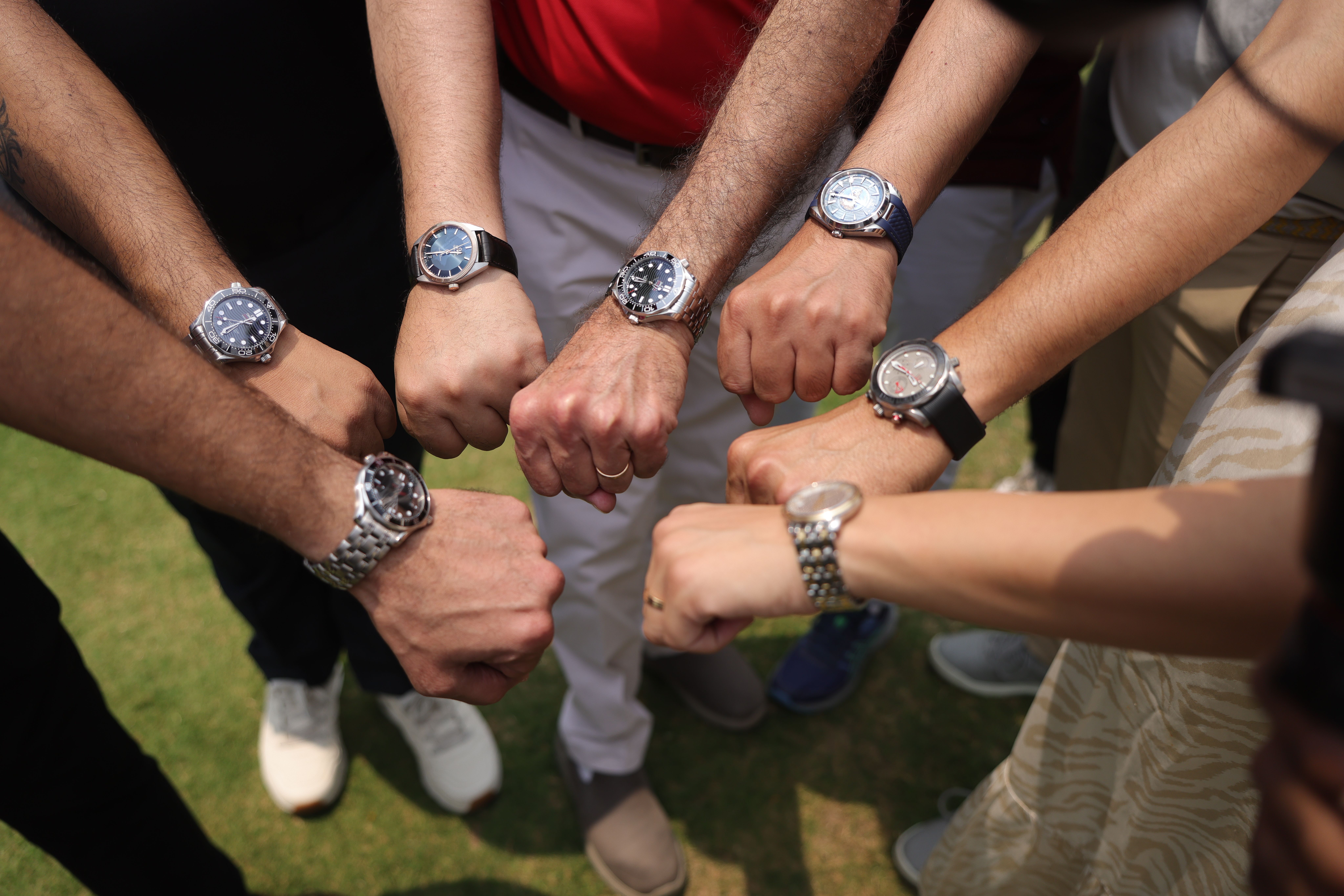 Golf players wearing Omega watches during tournament brand experience