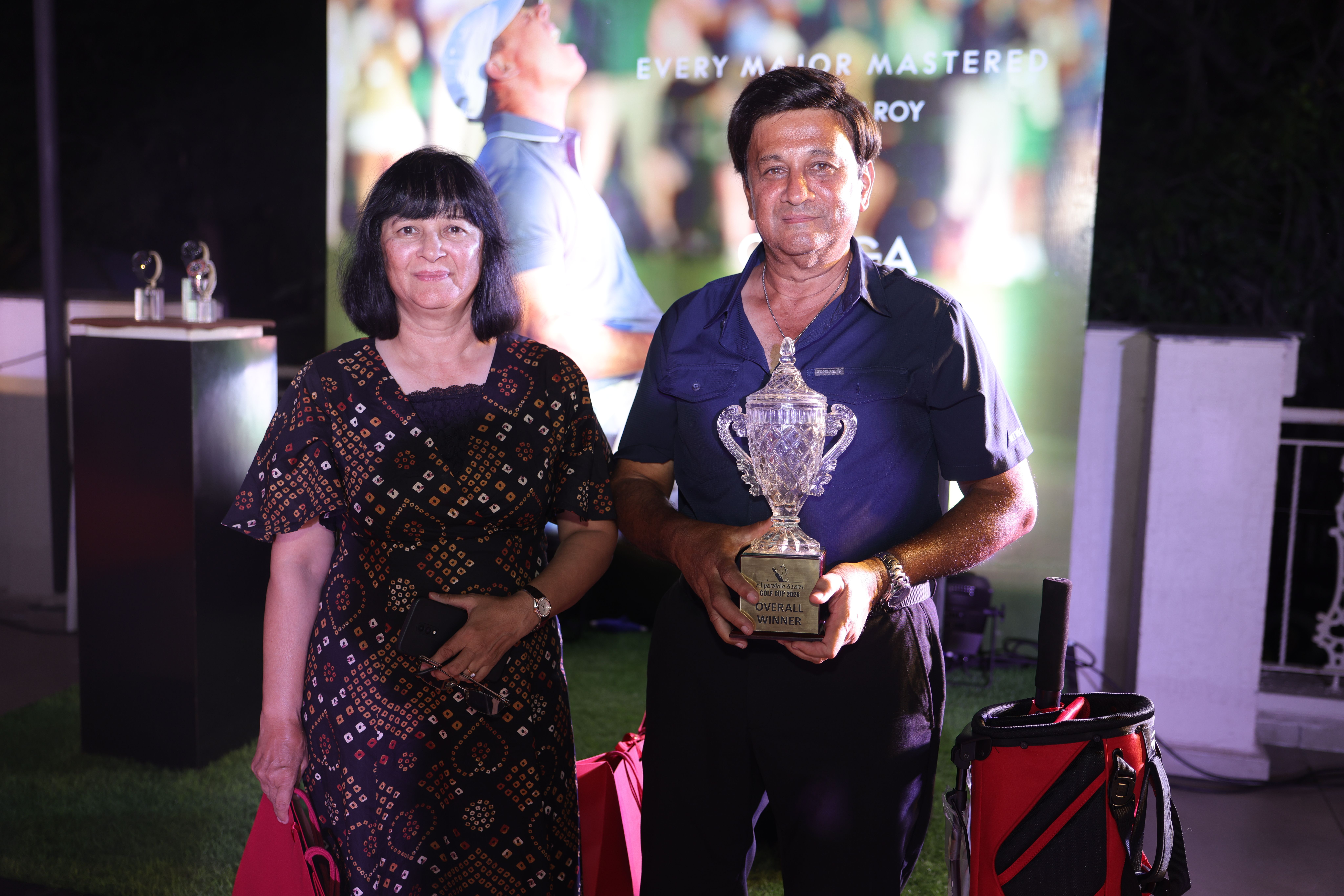 Golf tournament winner holding trophy Omega event Pune