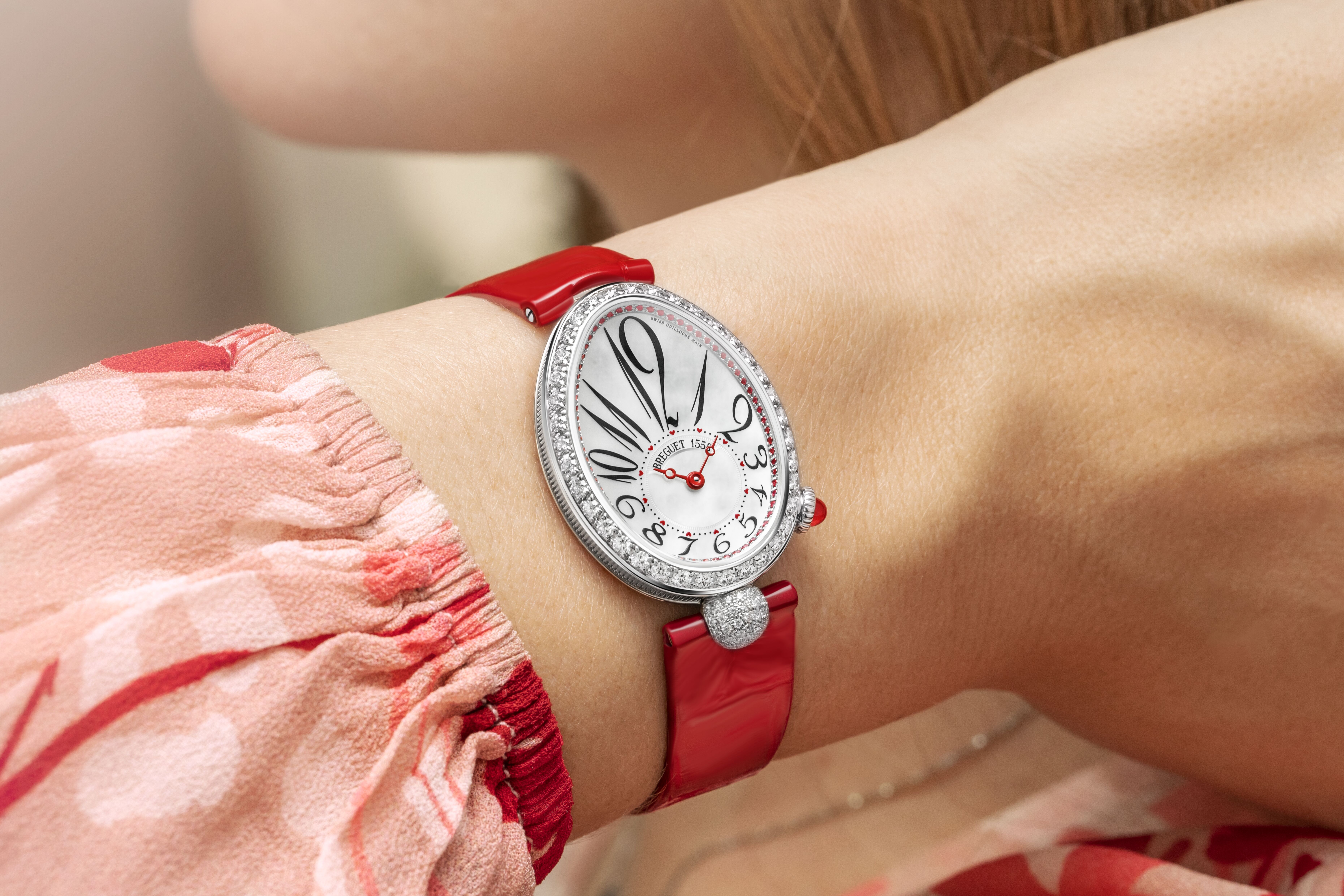 The red Reine de Naples strapped on the wrist