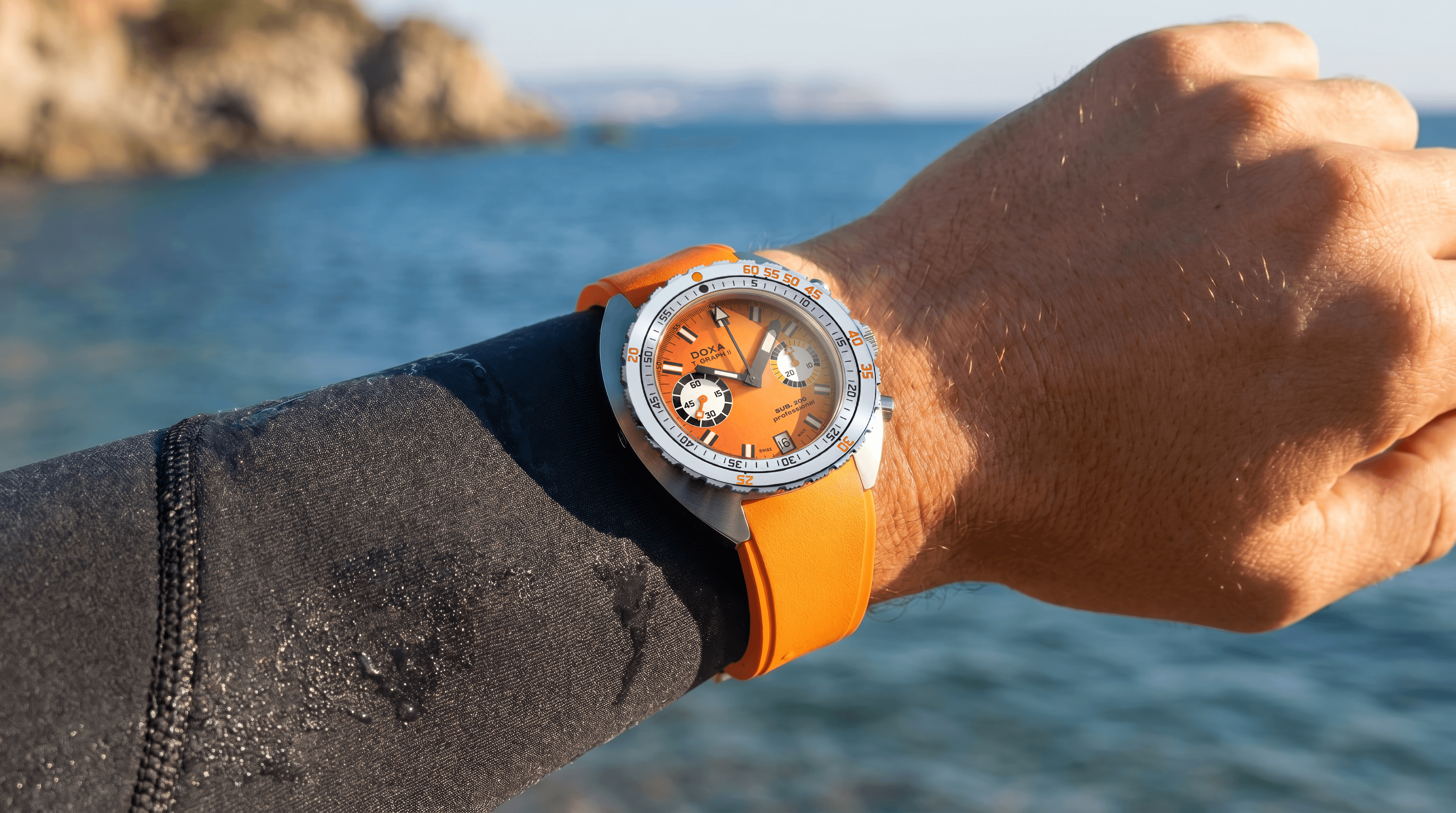 DOXA SUB 200 T.GRAPH II Professional Orange dive chronograph watch on an orange rubber strap, showcasing the updated 42mm case and vintage-inspired diving heritage.