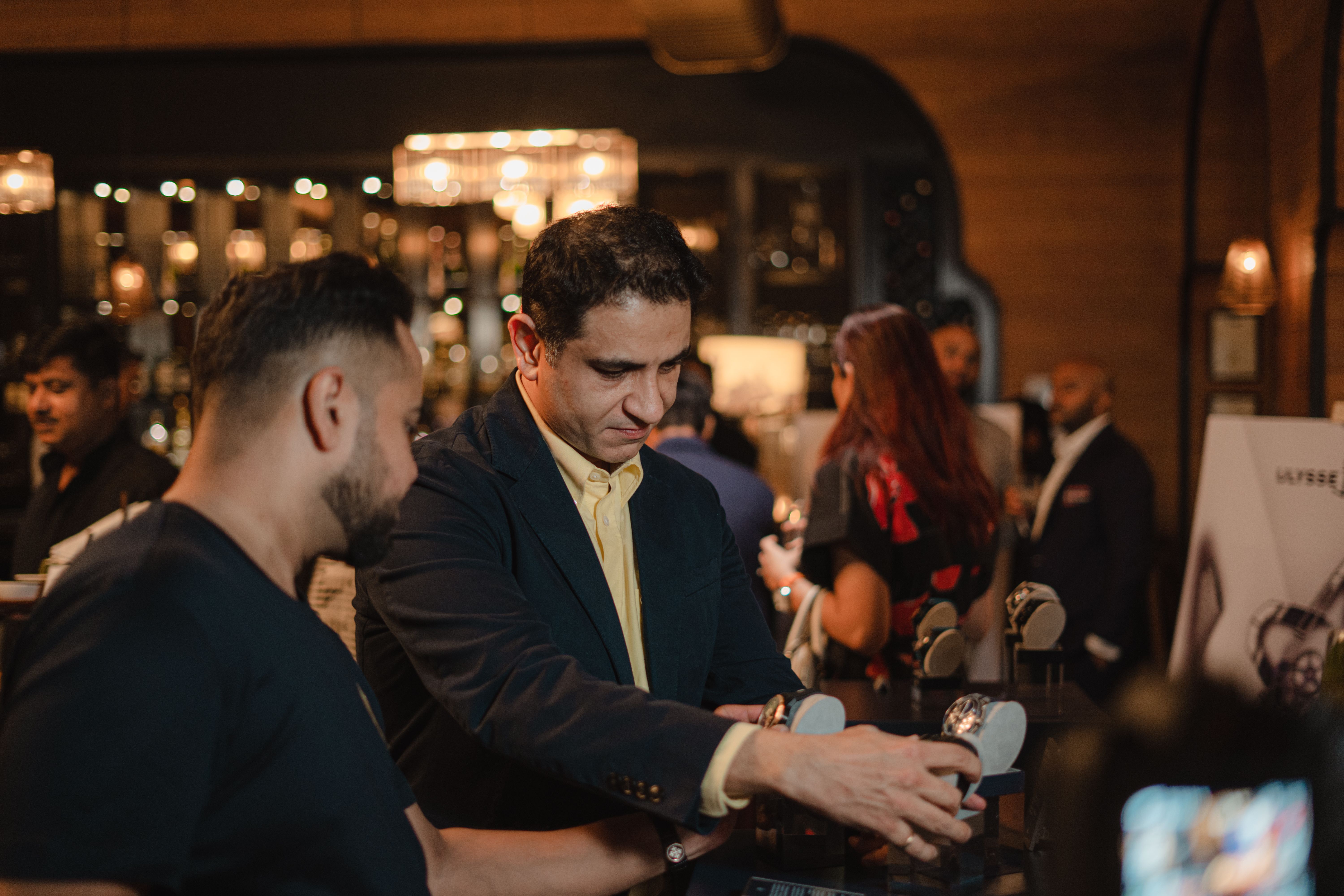 Luxury watch collectors discussing rare watches at a watch community meet and enthusiast gathering