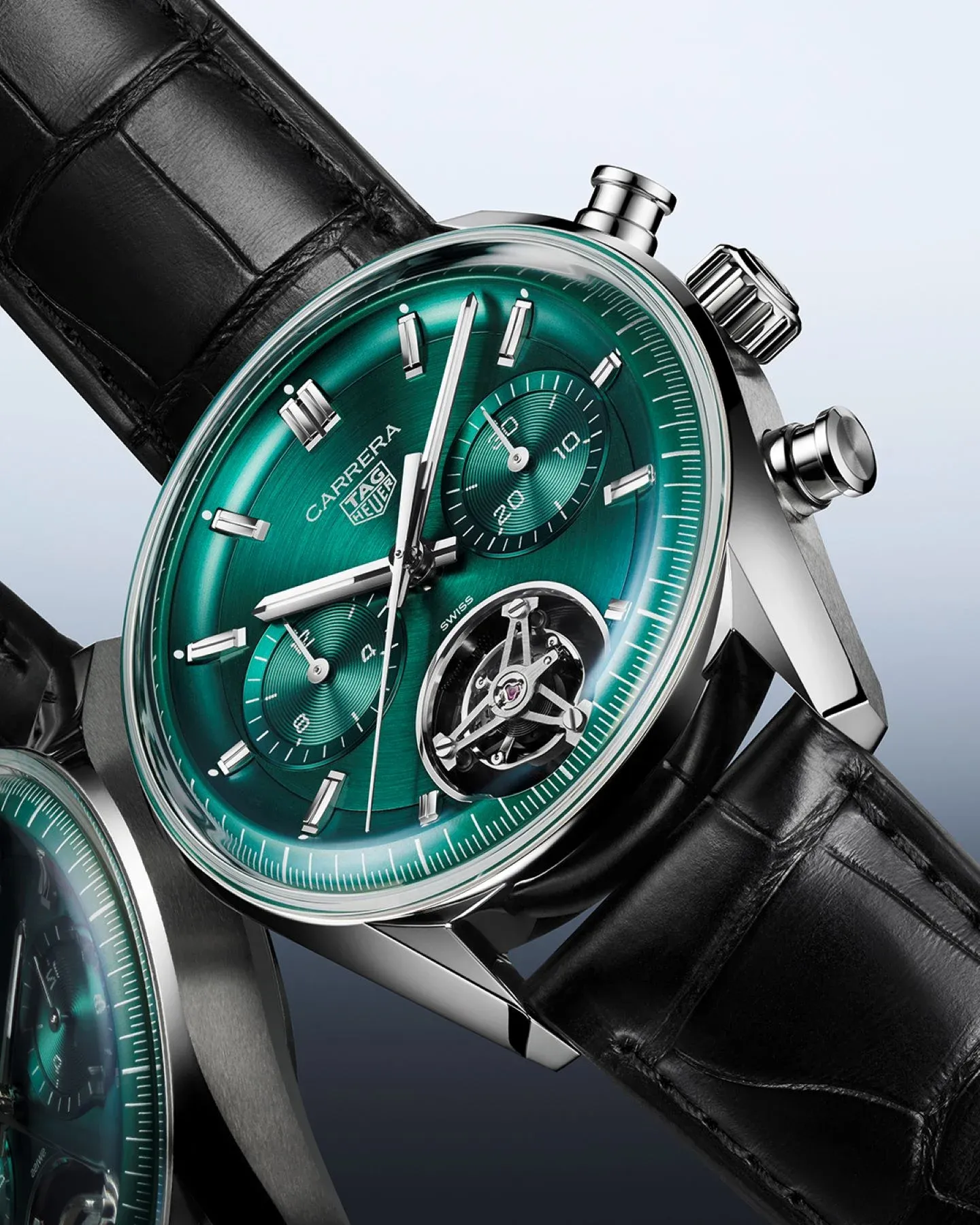The watch features an elegant teal green circular brushed dial