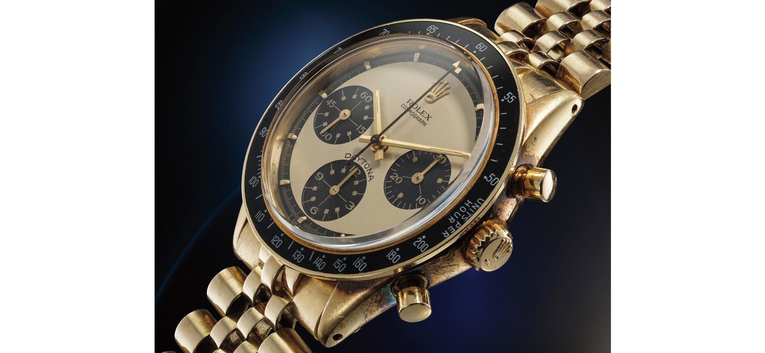 Rolex Ref. 6241 : A rare yellow gold chronograph wristwatch with bracelet and "Paul Newman" champagne dial. Image Credit @ Phillips