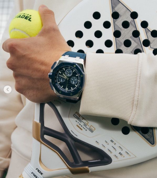 Audemars Piguet Royal Oak Offshore watch worn during padel play alongside racket and padel ball close up