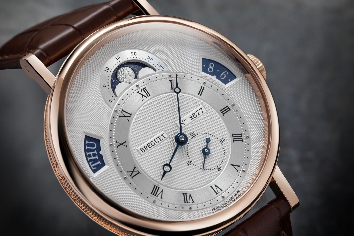A circular barleycorn design can be seen on the outer dial.