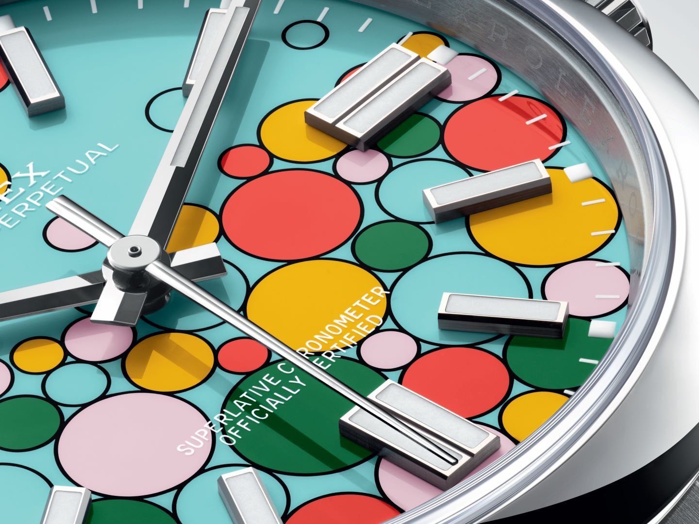 The lacquered turquoise dial of the Oyster Perpetual Celebration features an effervescent design of 51 bubbles in 5 colors