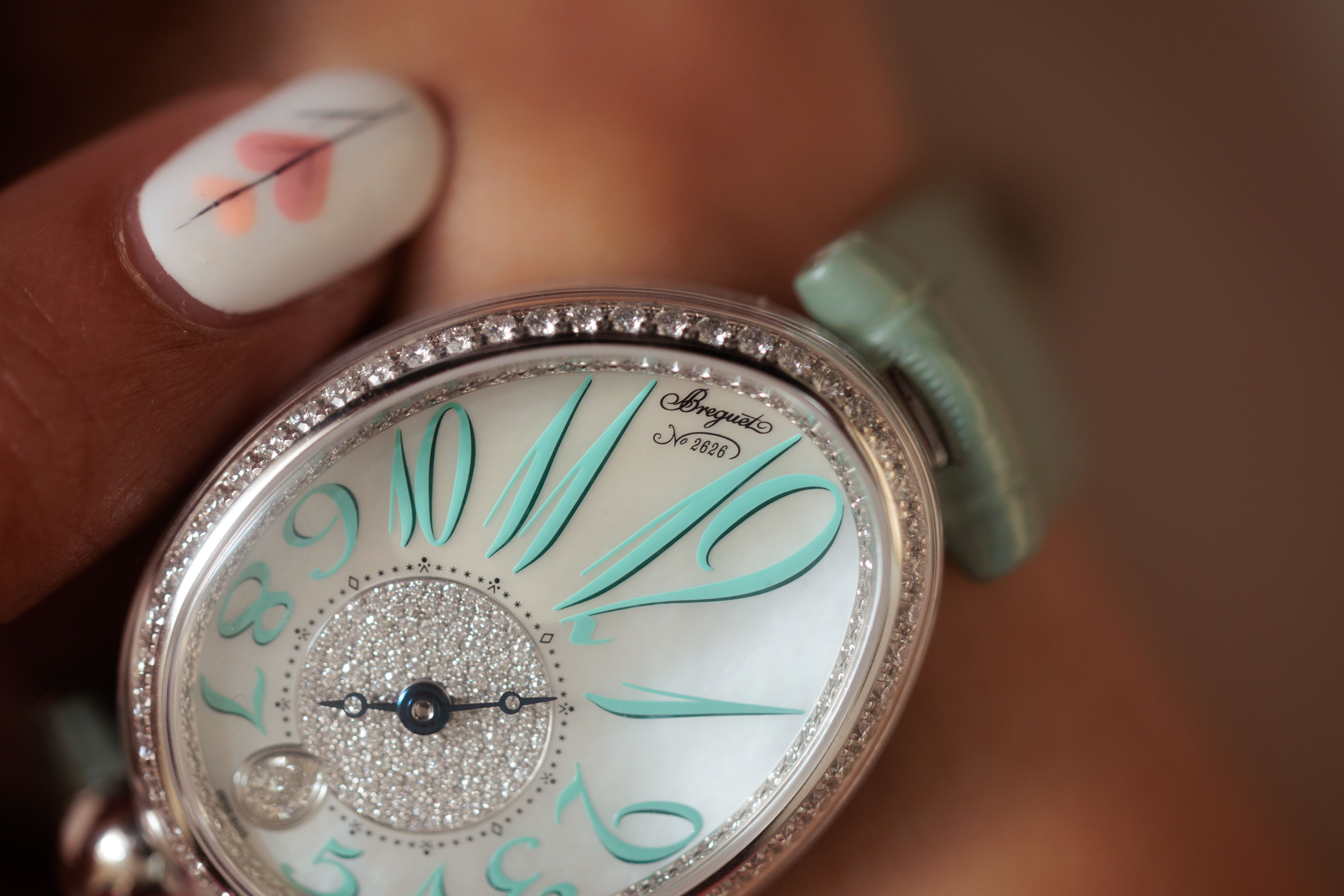 A close up of the mint green Reine de Naples egg shaped dial