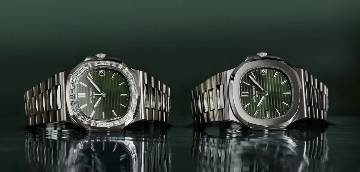 Two Patek Philippe Nautilus watches with green dials on display