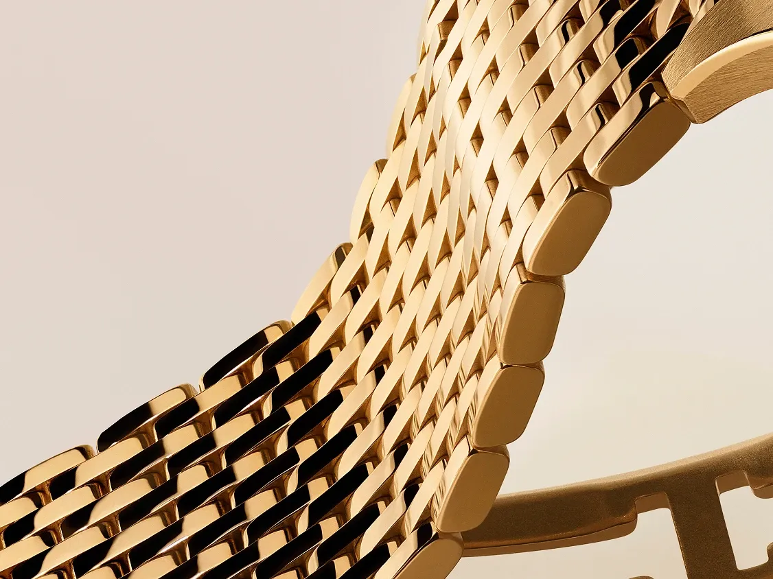 Close up of Cartier gold mesh bracelet showing intricate woven links and high precision finishing at Watches And Wonders 2026