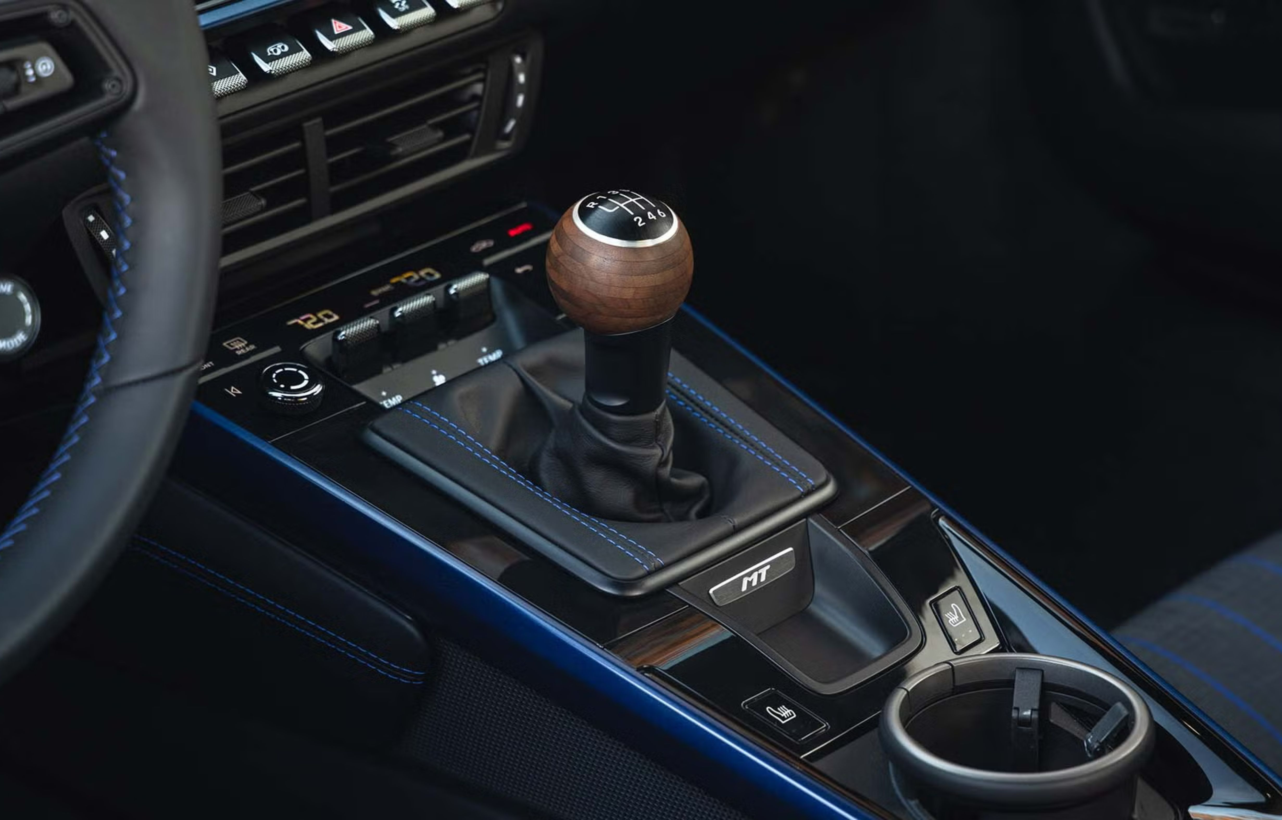 Manual car gear shifter representing analog precision and mechanical experience compared to smart watchmaking